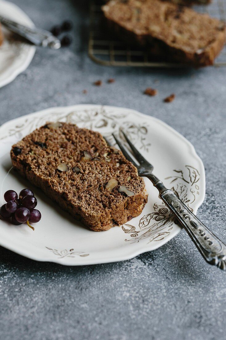 A slice of zucchini and walnut bread placed on a plate