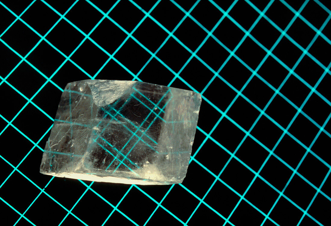 Calcite crystal upon a grid pattern