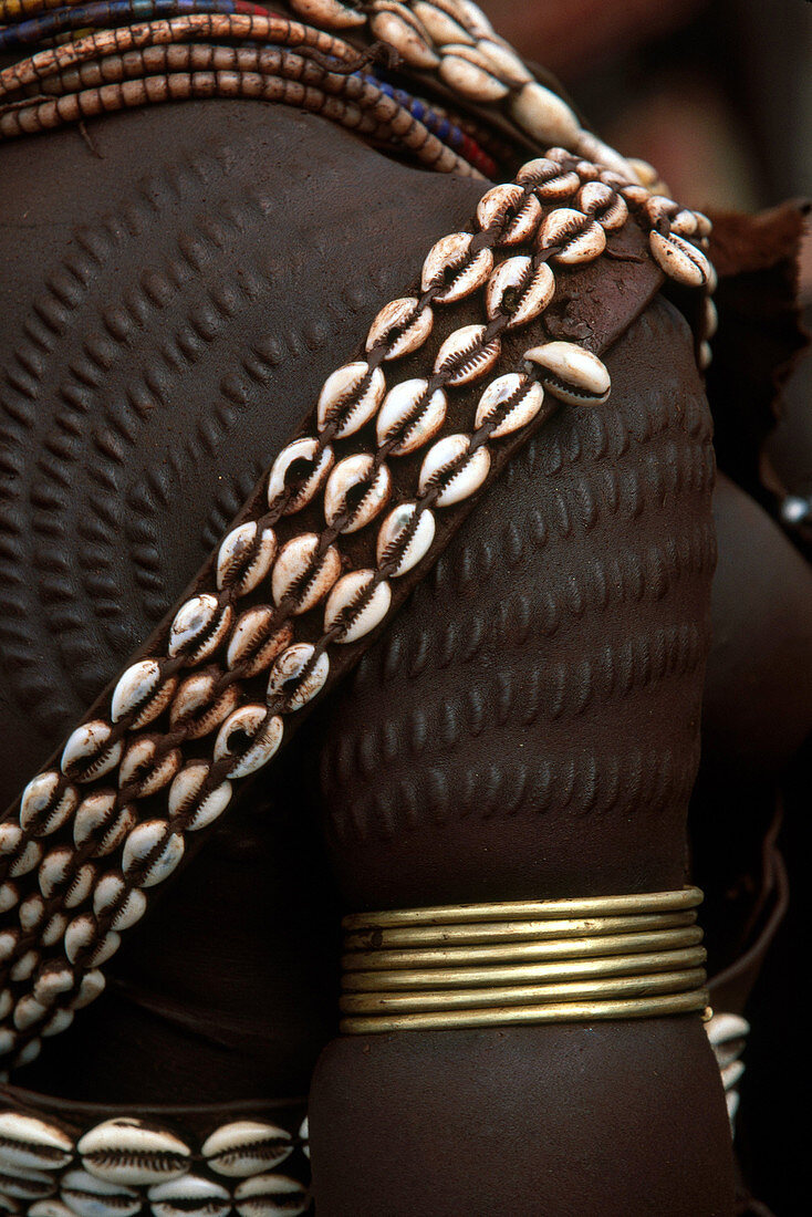Person showing cowry shell detail