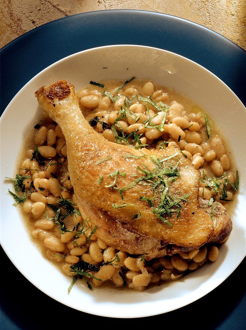 Cassoulet with duck leg in deep plate