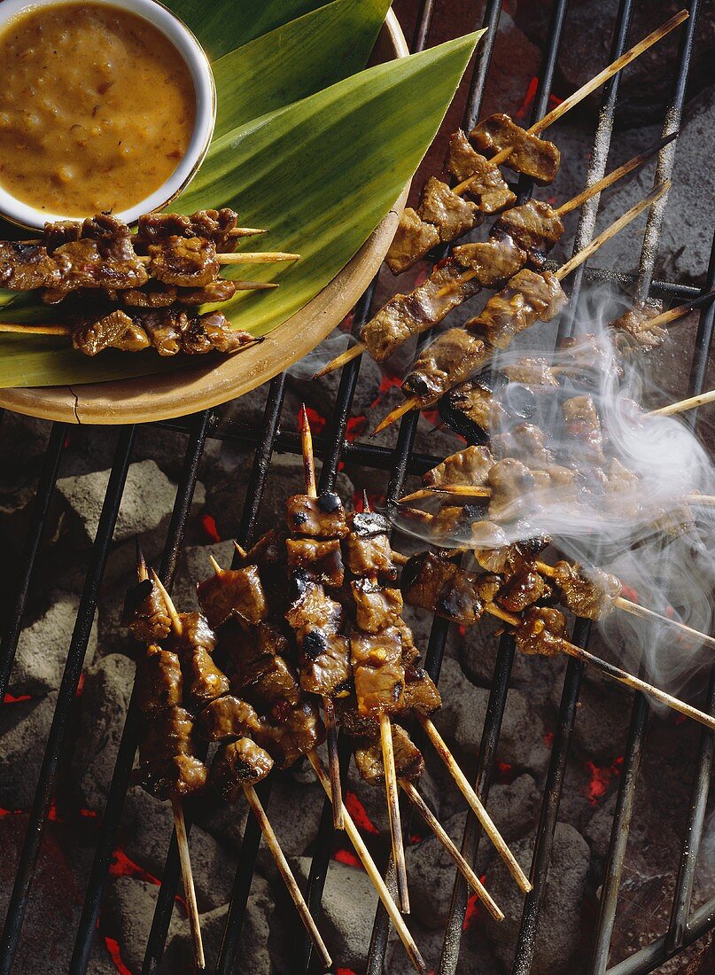 Beef Satay Cooking on a Grill; Smoke