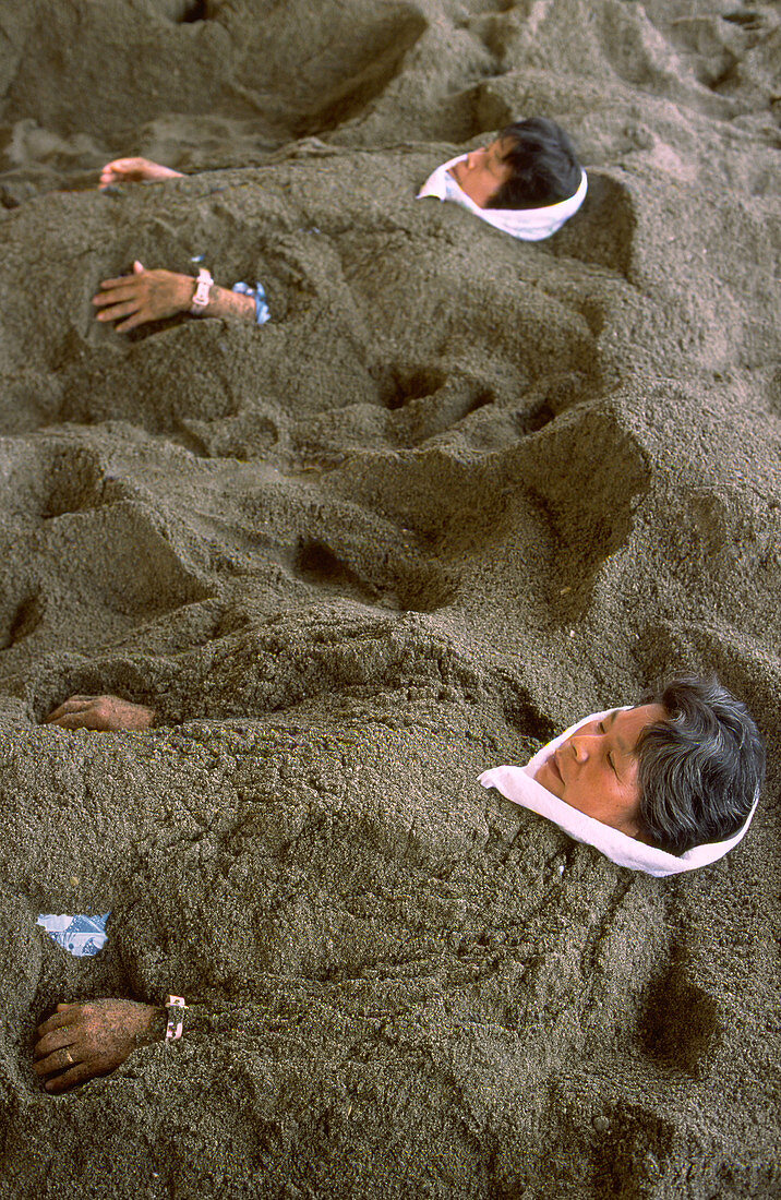 People buried in hot sand