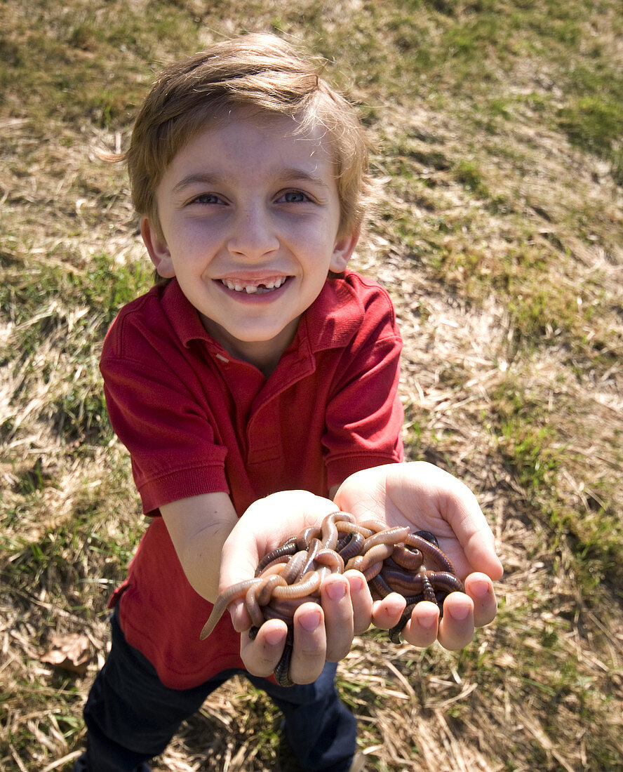 Young Boy with Worms in Hands