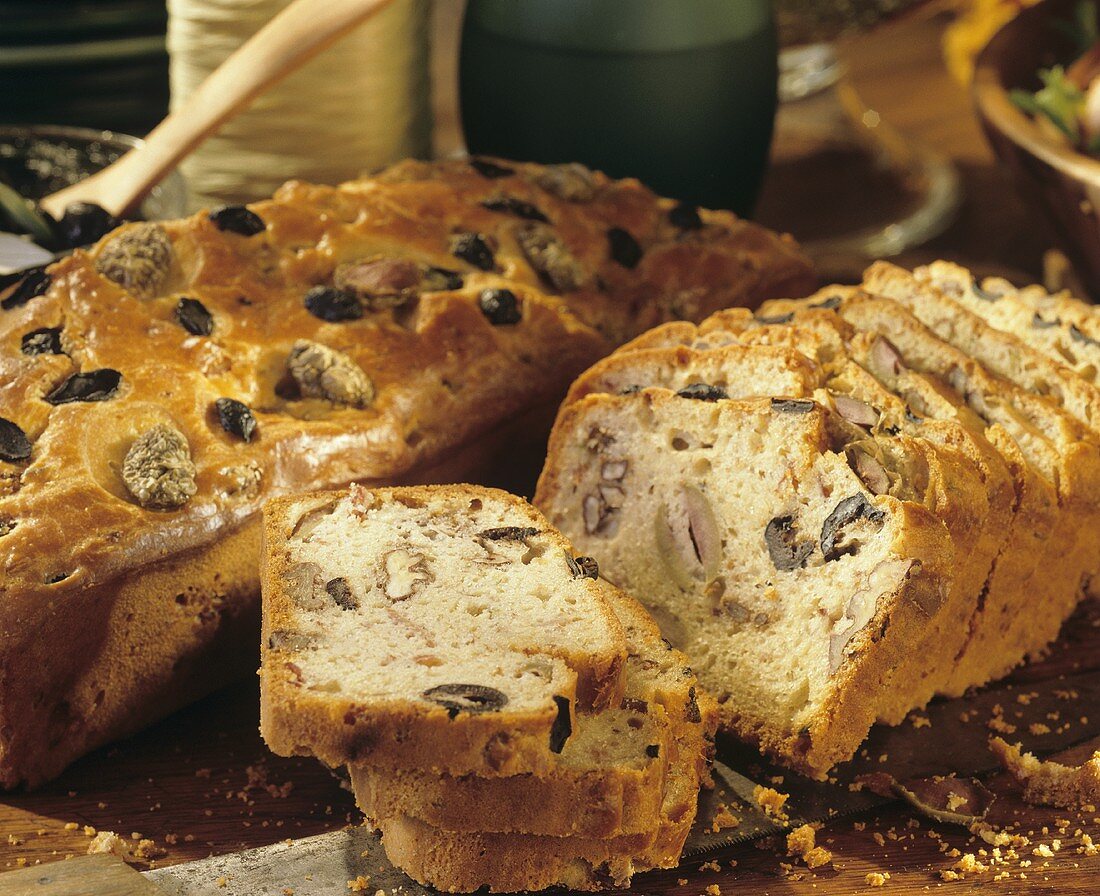 Olive bread being cut on the table