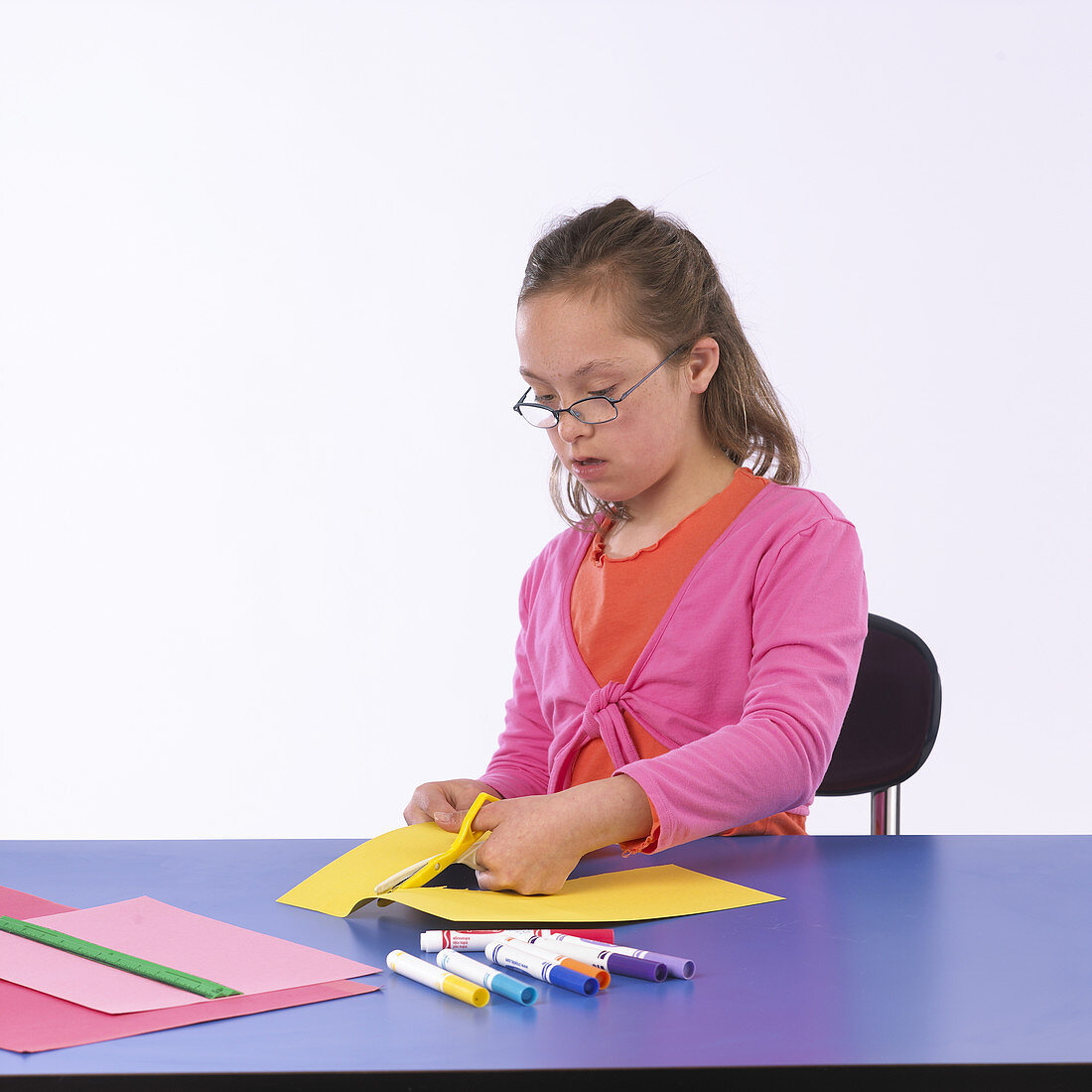 Girl with Special Needs Cutting Paper