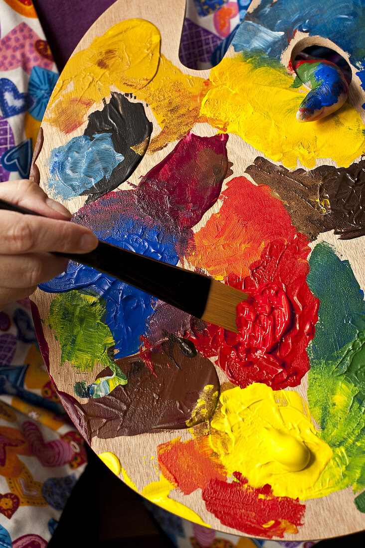 Woman Holding Palette and Paint Brush