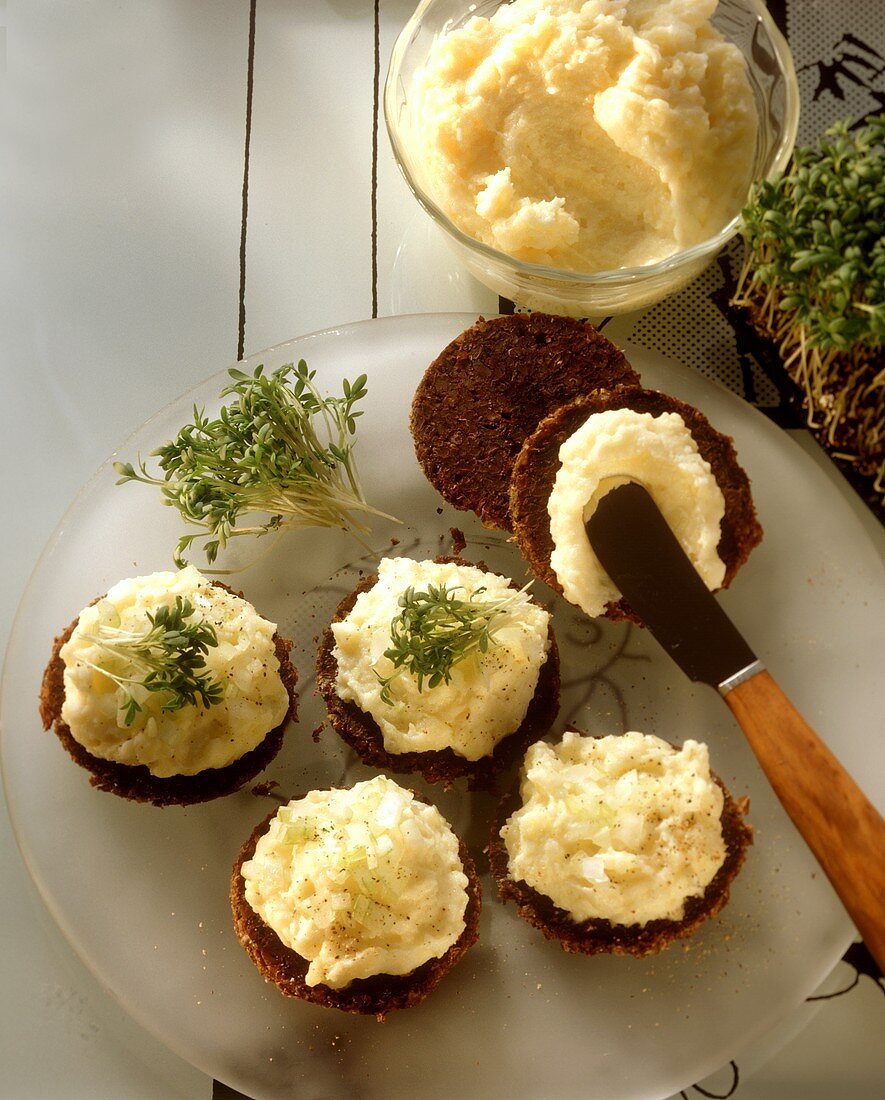 Spreading Potato Mousse on Pumpernickel Rounds