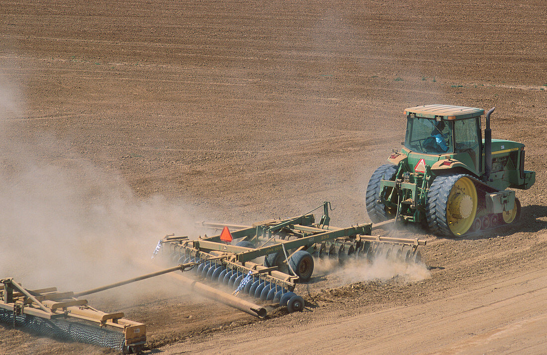 Tractor disking a field