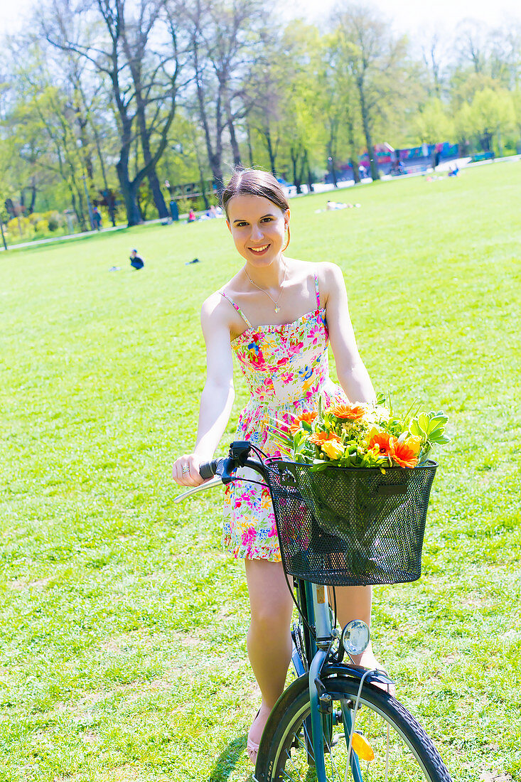 Woman on bicycle in a park in summer