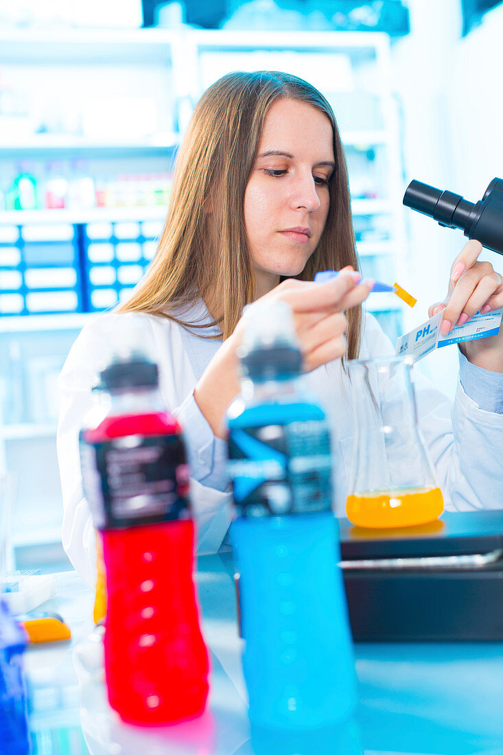 Scientist testing food samples in a flask