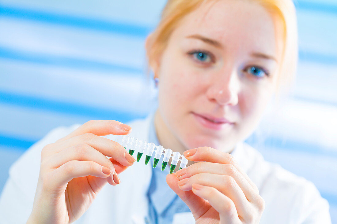 Lab technician holding eppendorf tubes