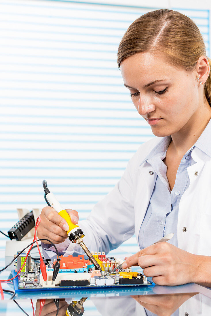Technician working on a circuit board