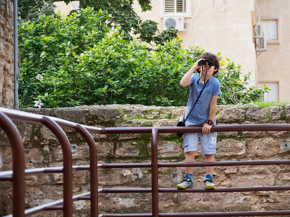 Boy of seven with a binocular