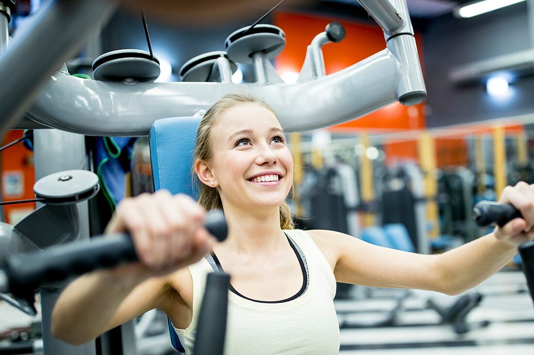 Young woman doing chest press