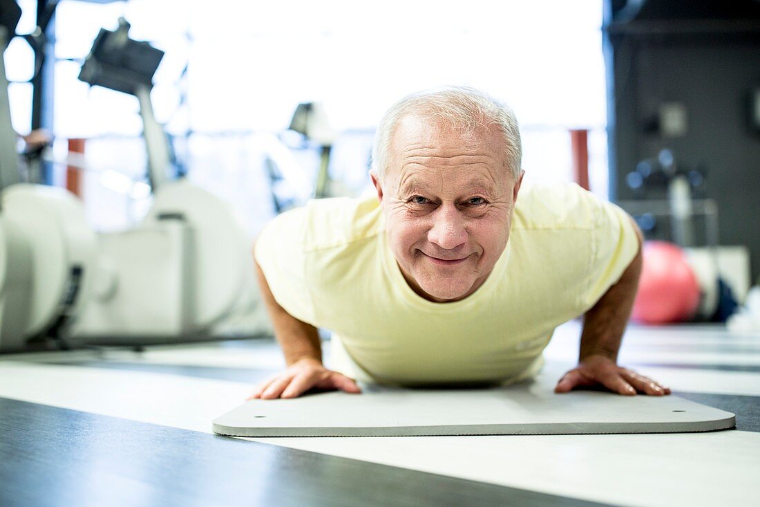 Senior man exercising in gym