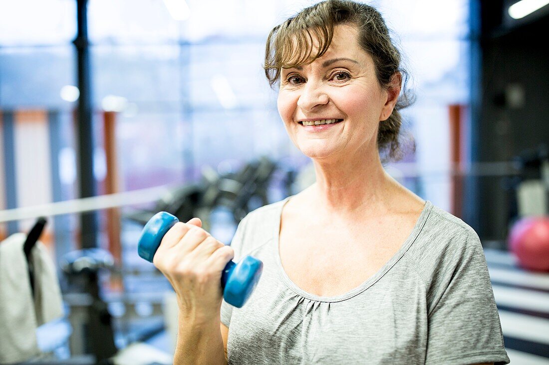 Senior woman holding dumbbell