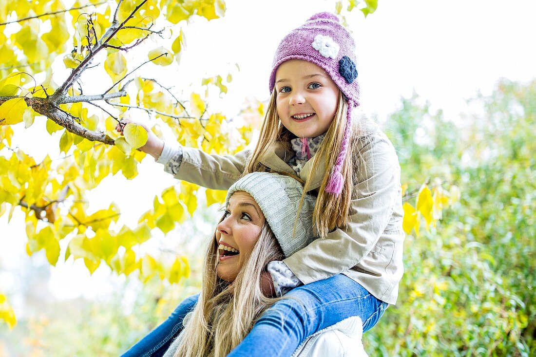 Mother and daughter looking at branch