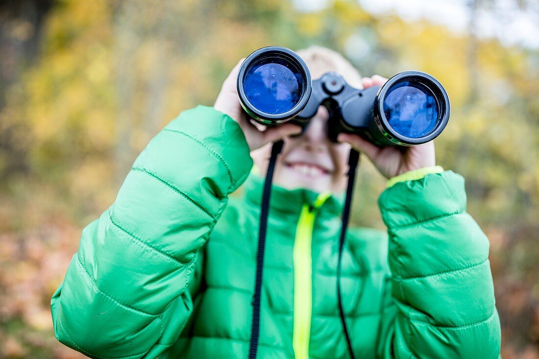 Boy looking through binoculars