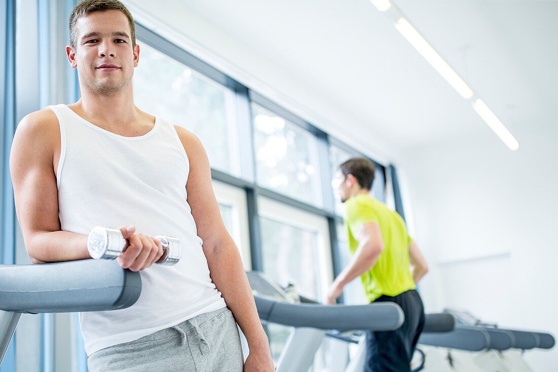 Young man holding dumbbells