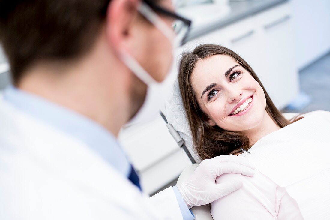 Dentist and patient smiling