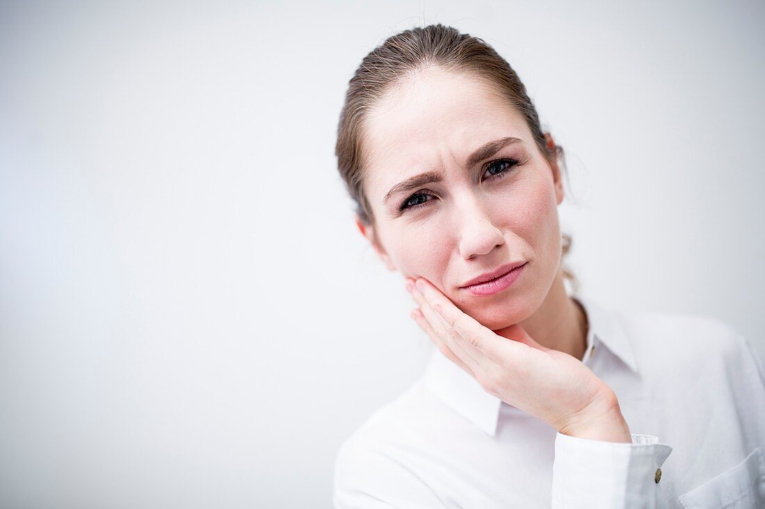 Young woman suffering toothache