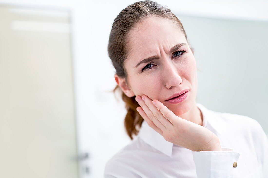 Young woman suffering toothache