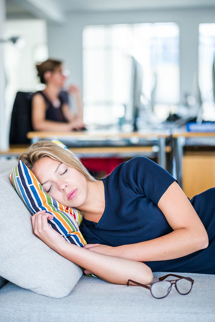 Woman taking a nap in the office