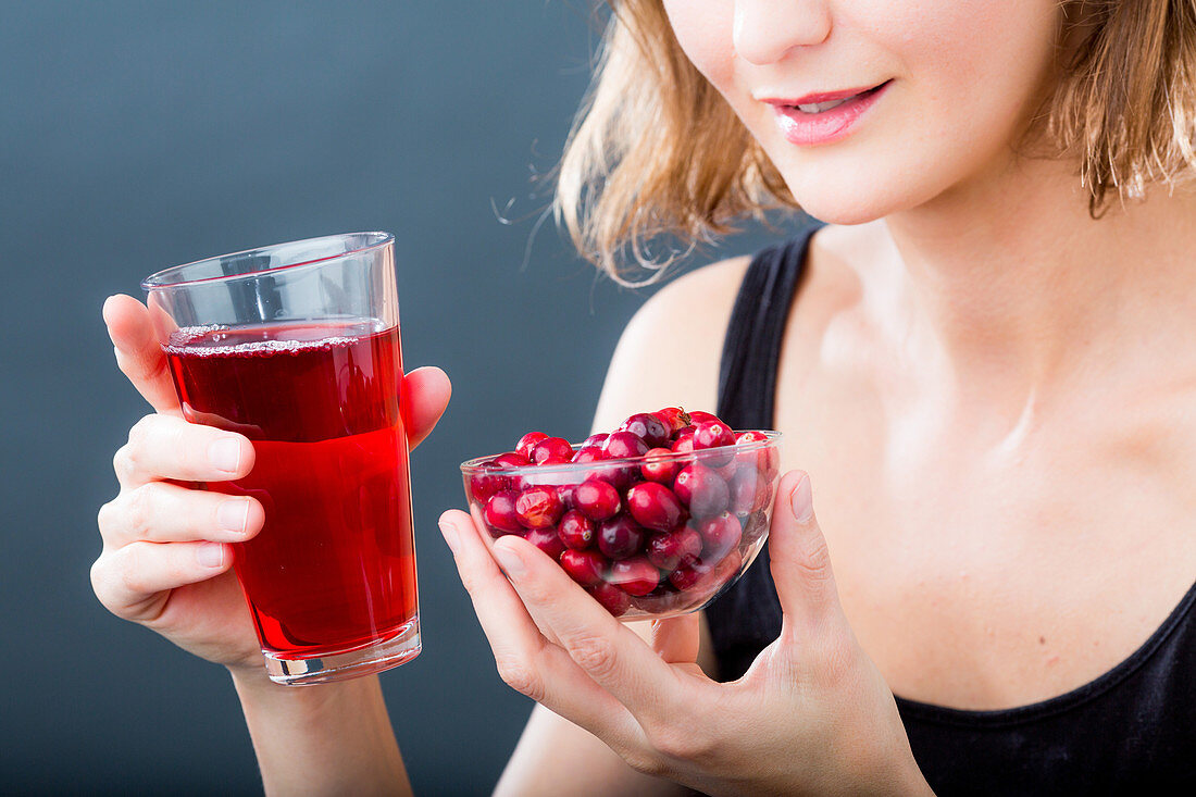 Woman drinking a glass of cranberry juice