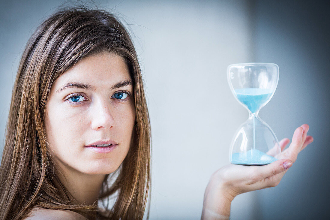 Woman holding an hourglass
