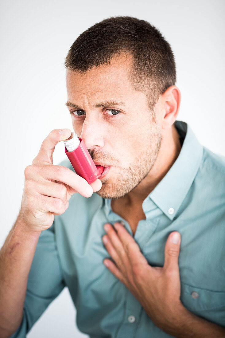 Man using an inhaler during an asthma attack