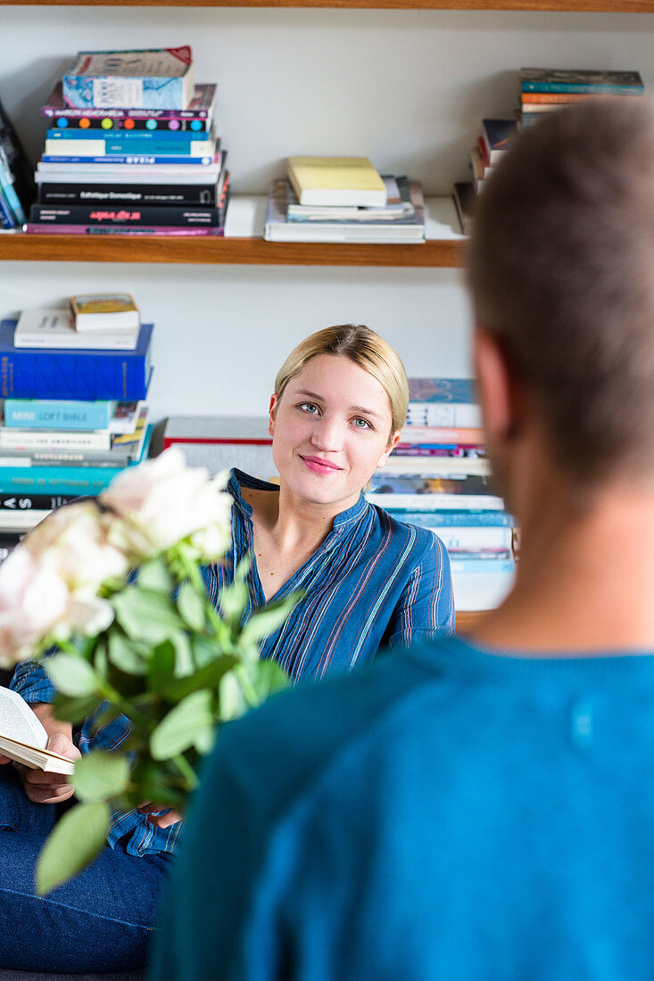 Man offering his partner a bunch of flowers
