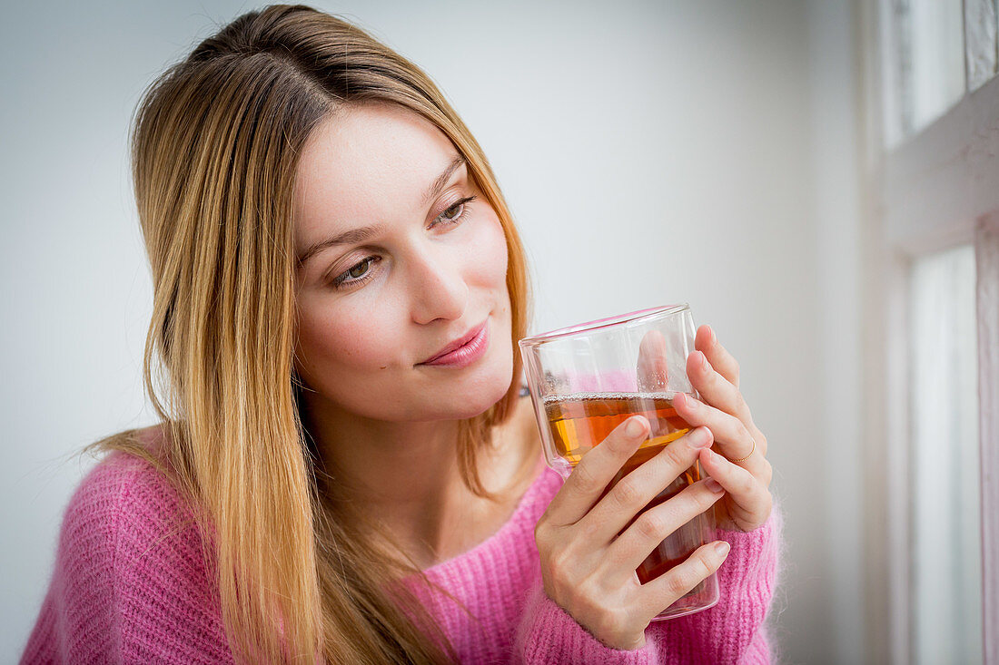 Woman drinking hot beverage