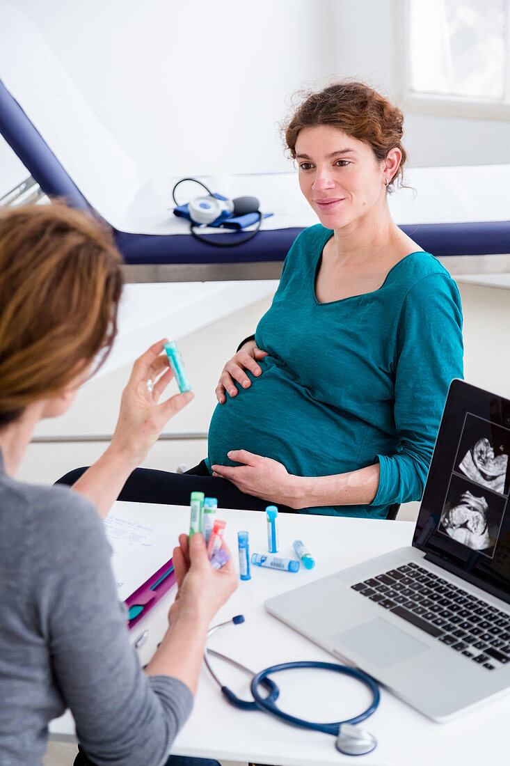 Pregnant woman in consultation with a gynaecologist