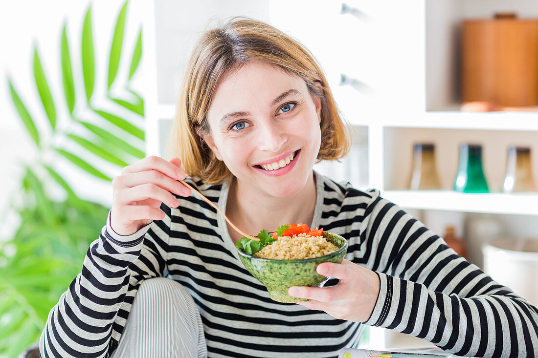 Woman eating a quinoa salad