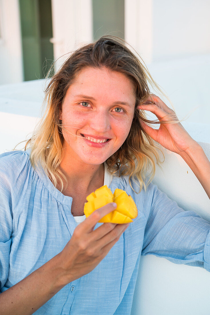Woman eating mango