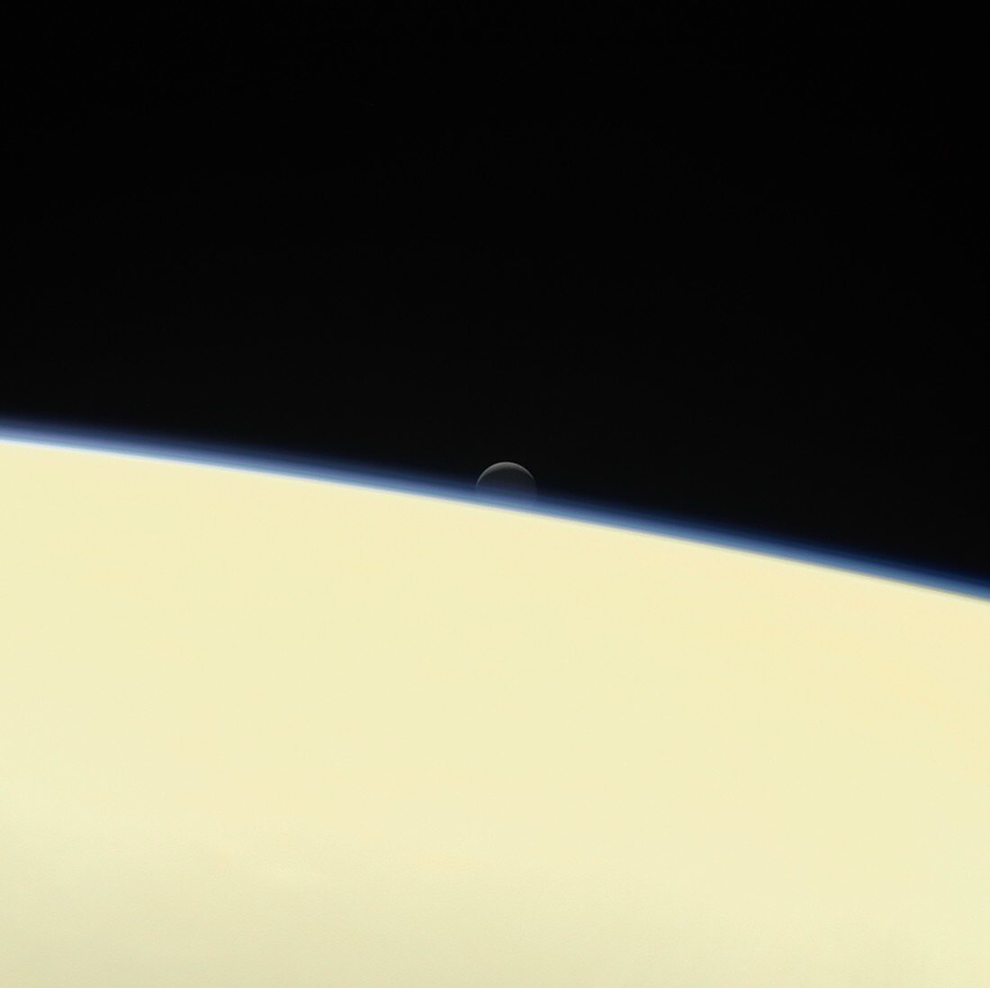 Enceladus setting behind Saturn, Cassini image