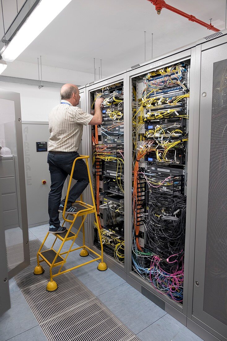 Technician checking server cables