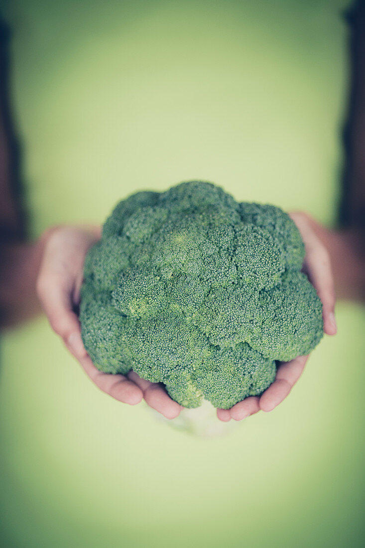 Woman holding broccoli