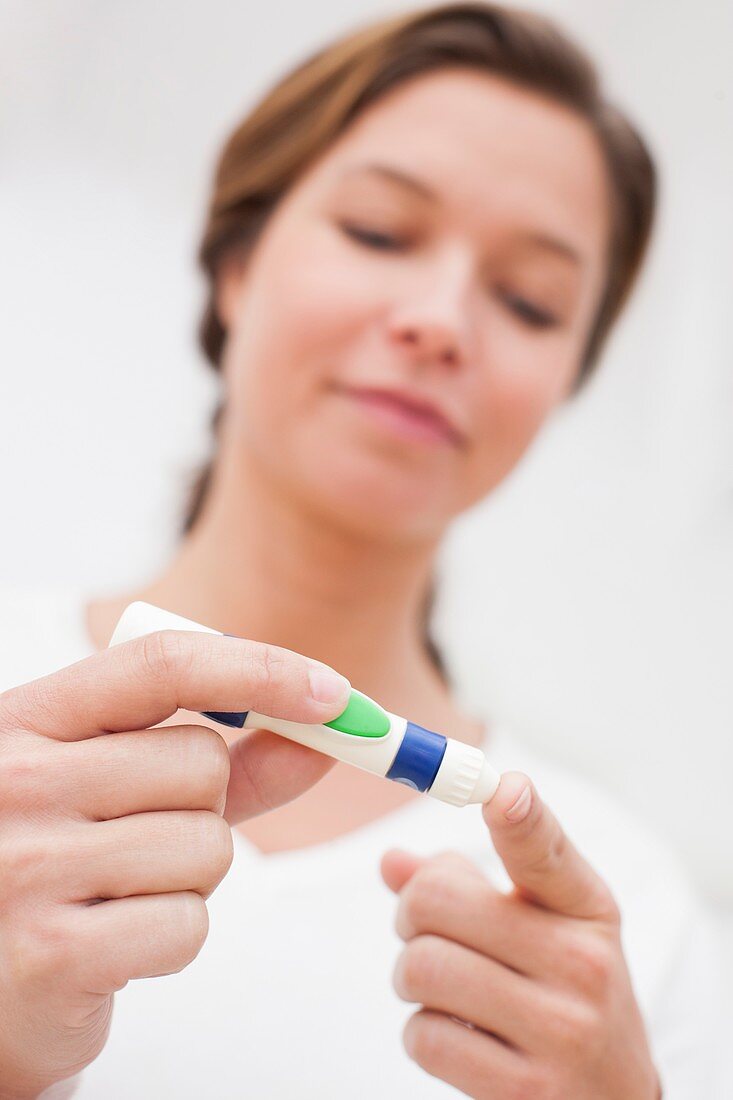 Woman testing glucose