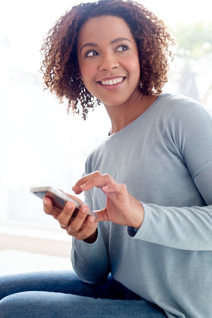 Mid adult woman using phone