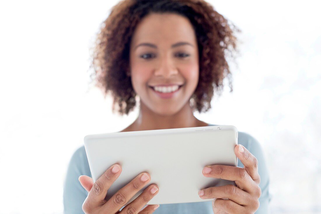 Mid adult woman using tablet