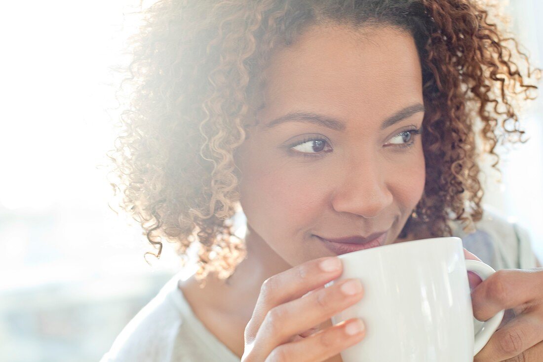Mid adult woman drinking coffee