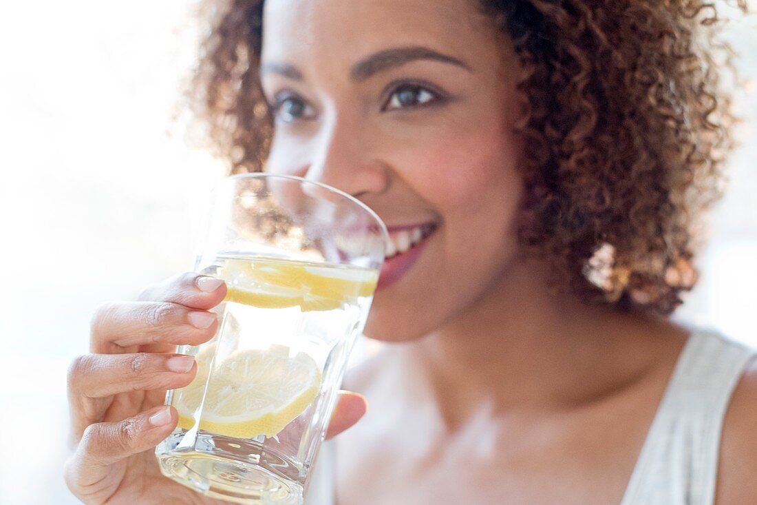 Mid adult woman drinking water