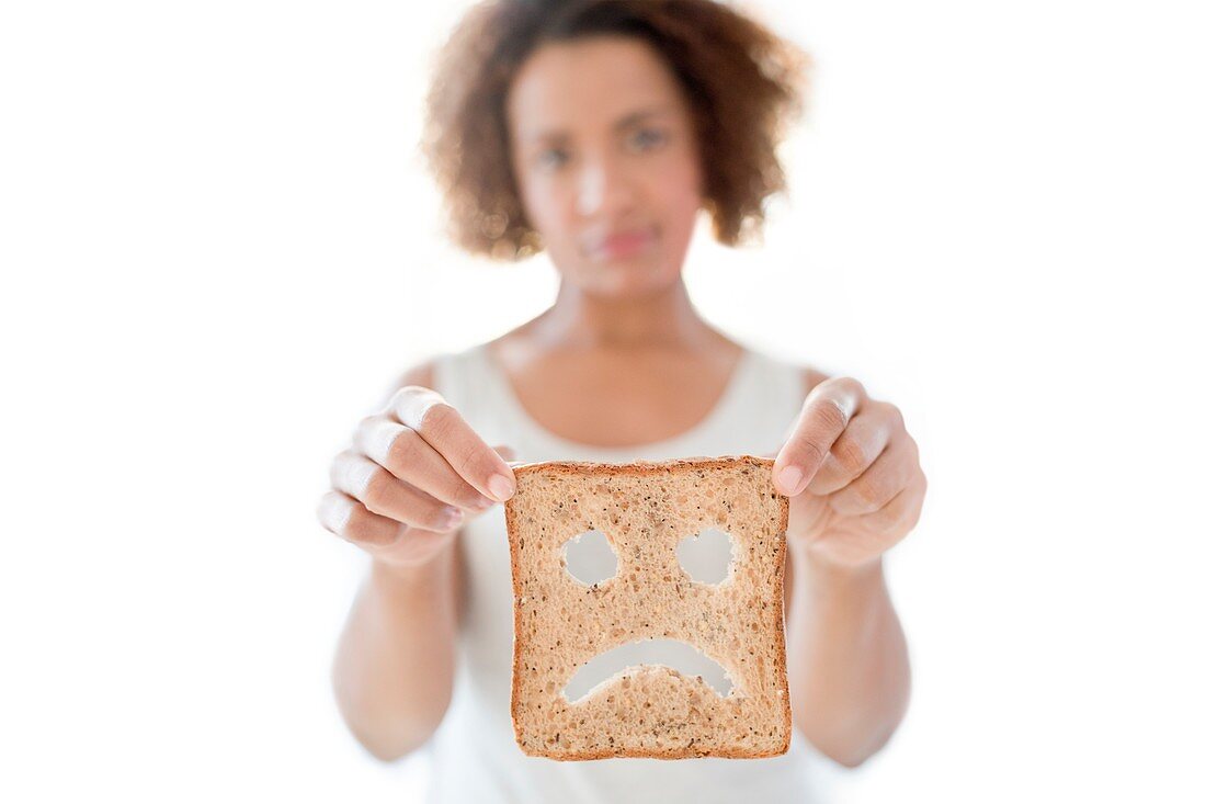 Woman holding bread with sad face