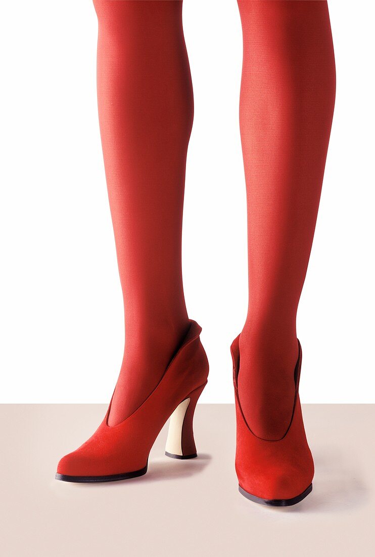 Woman wearing red tights and high heels