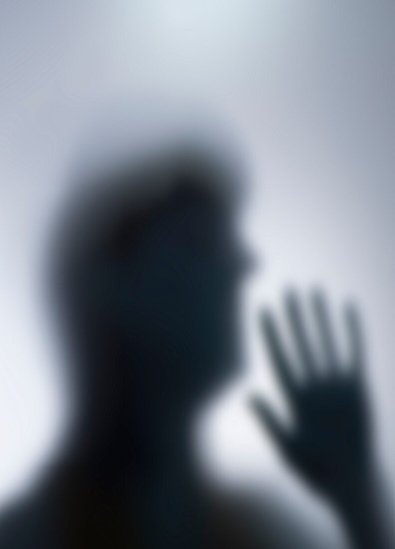 Silhouette of person's head and hand