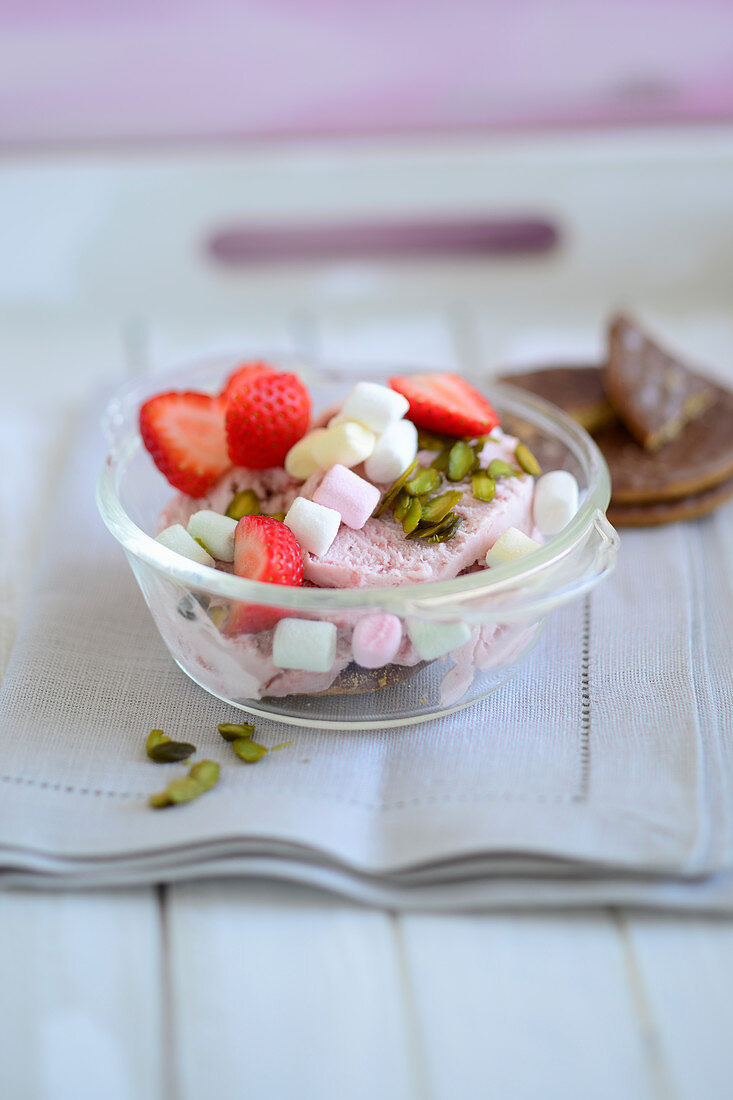 Strawberry ice cream with marshmallows, pistachios and fresh strawberries