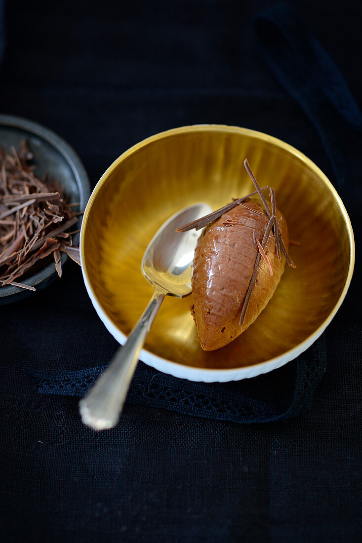 A scoop of chocolate mousse with grated chocolate