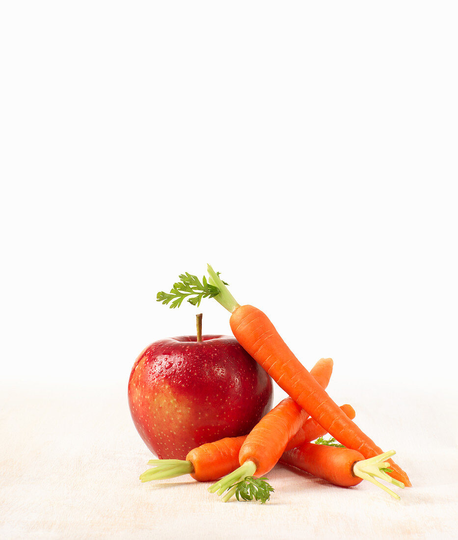 A red apple and carrots