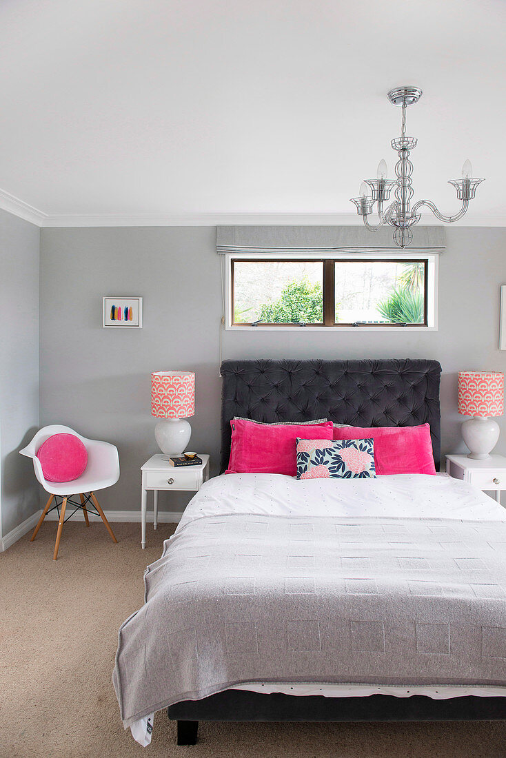 Bedroom in gray and white with color accents in pink